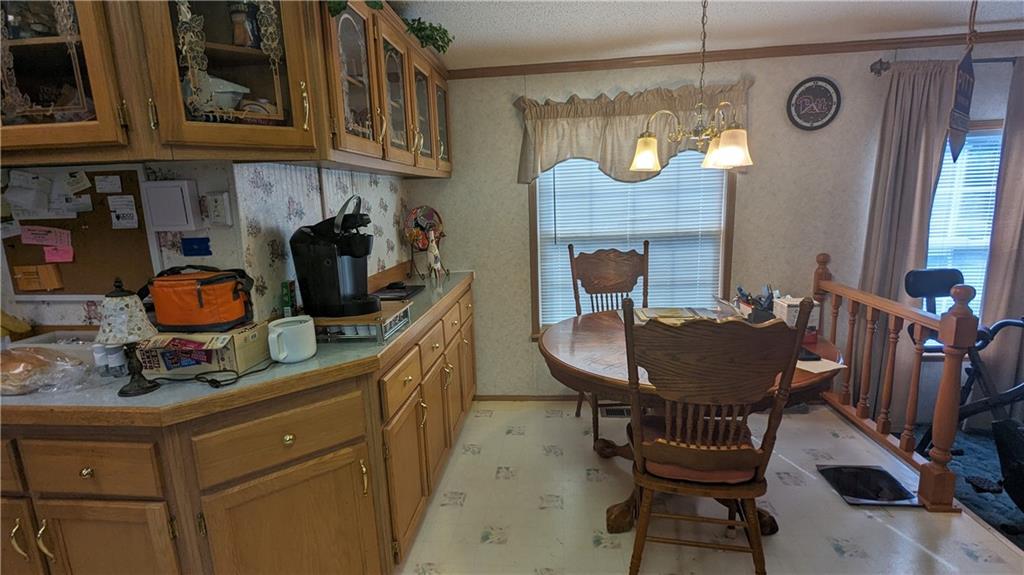542 Finks Run Road McDonald, PA 15057 - Photo 15 of 28 a kitchen with a stove a sink and a dining table with chairs