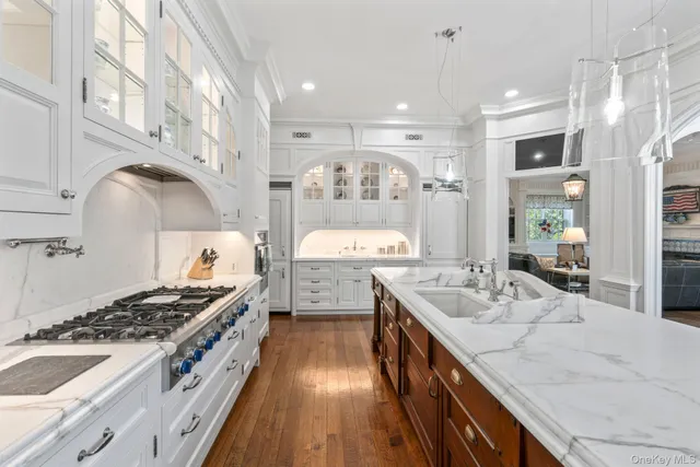 a kitchen with a stove sink and cabinets