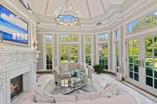 a living room with furniture and a chandelier