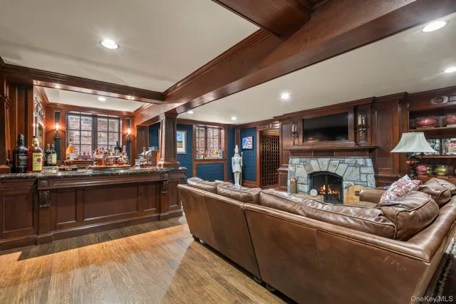 a living room with furniture a fireplace and a kitchen view