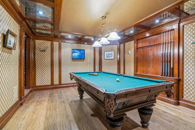 a room with pool table and windows