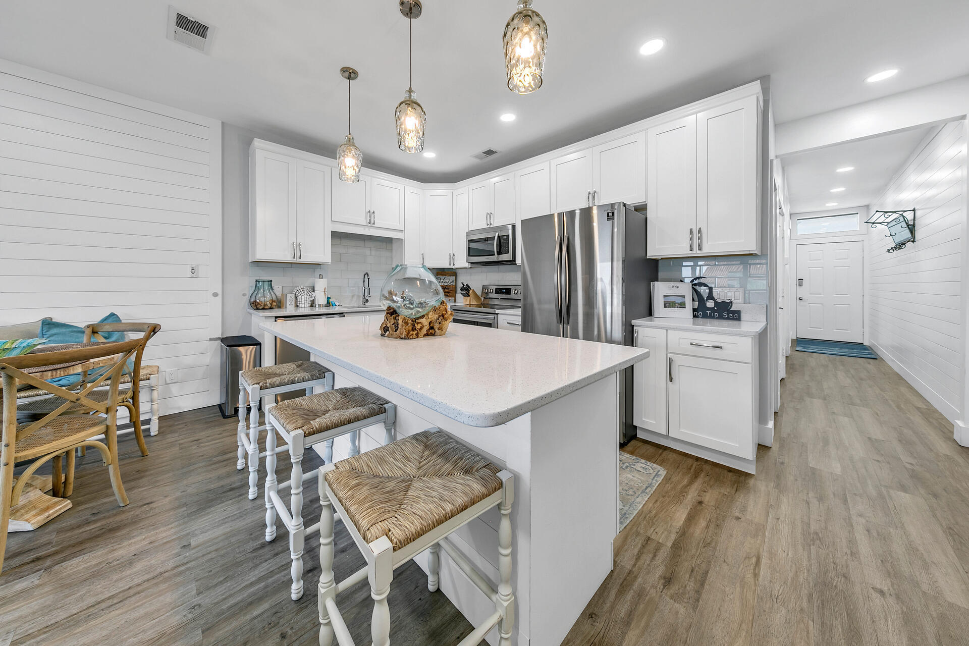3604 East County Highway 30A, Unit B8 Santa Rosa Beach, FL 32459 - Photo 11 of 39 a kitchen with stainless steel appliances a dining table chairs stove microwave and cabinets