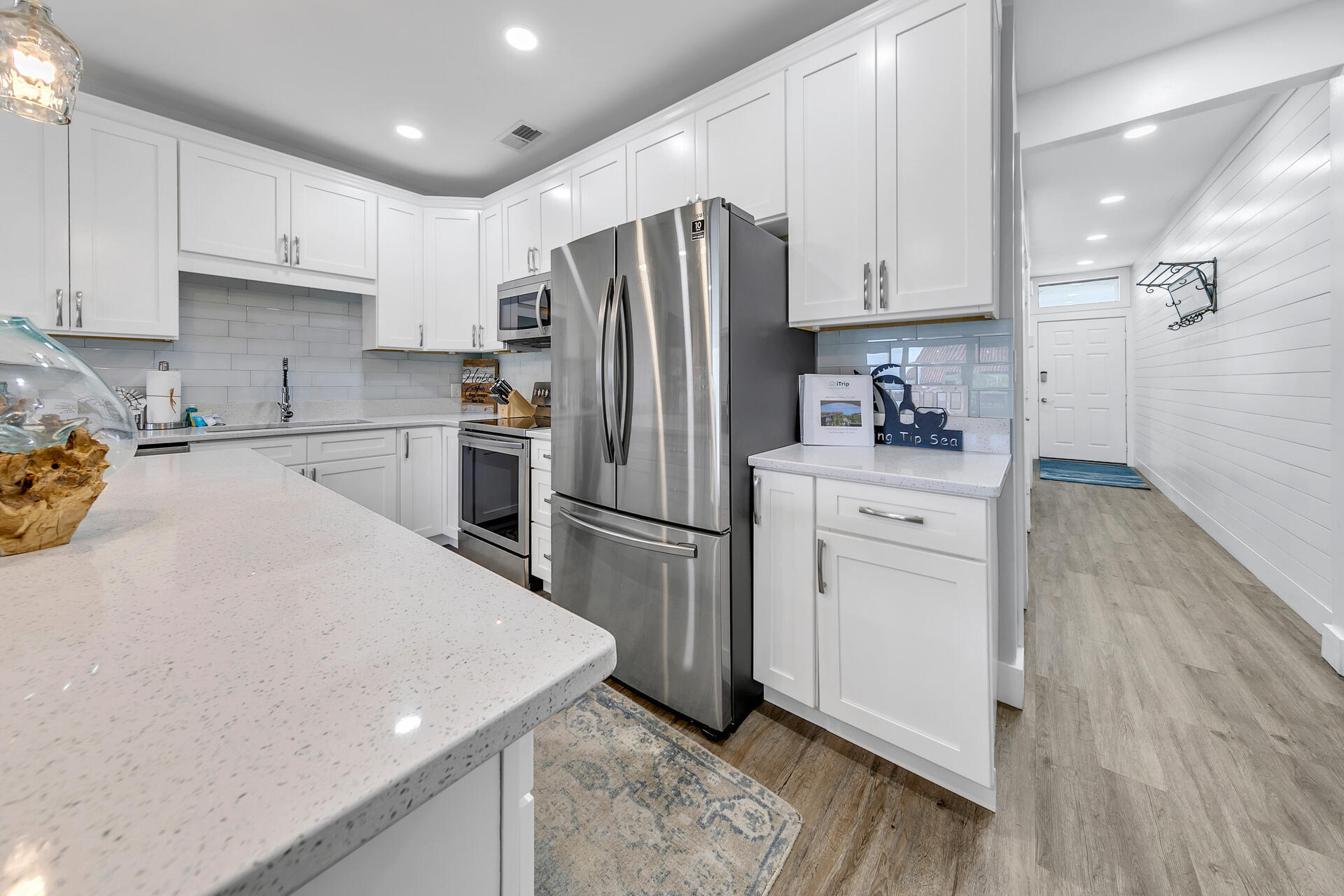 3604 East County Highway 30A, Unit B8 Santa Rosa Beach, FL 32459 - Photo 12 of 39 a kitchen with a sink a refrigerator and white cabinets