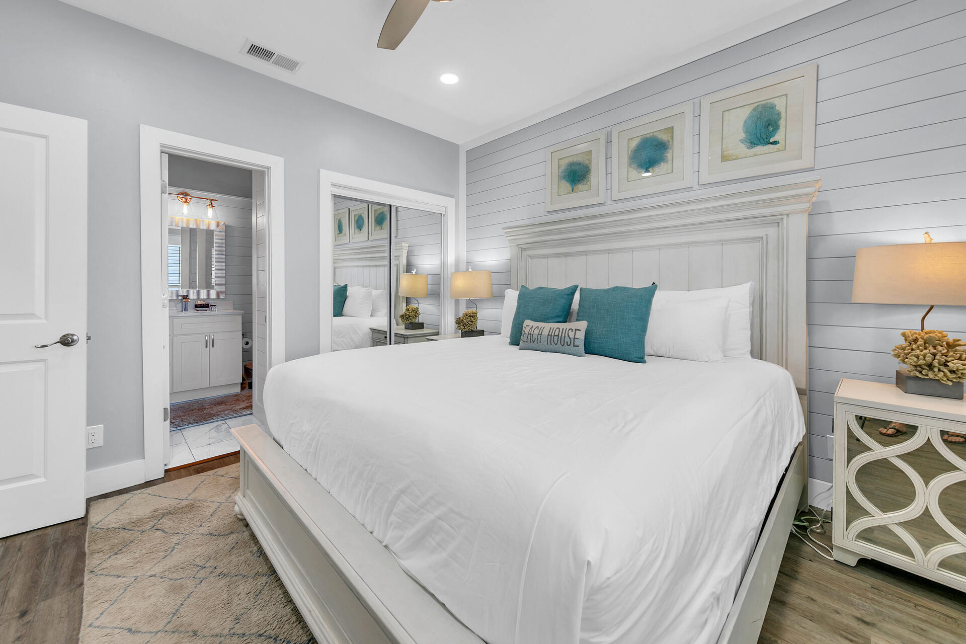 3604 East County Highway 30A, Unit B8 Santa Rosa Beach, FL 32459 - Photo 20 of 39 a bedroom with a bed a mirror and lamp