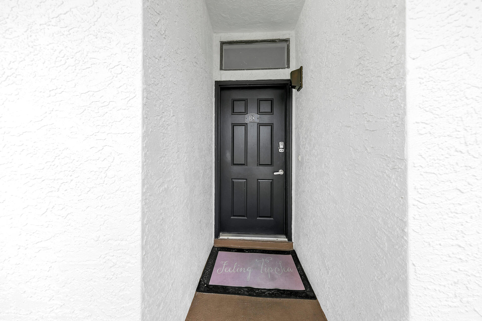 3604 East County Highway 30A, Unit B8 Santa Rosa Beach, FL 32459 - Photo 24 of 39 a view of a hallway with wooden floor and a white cabinet