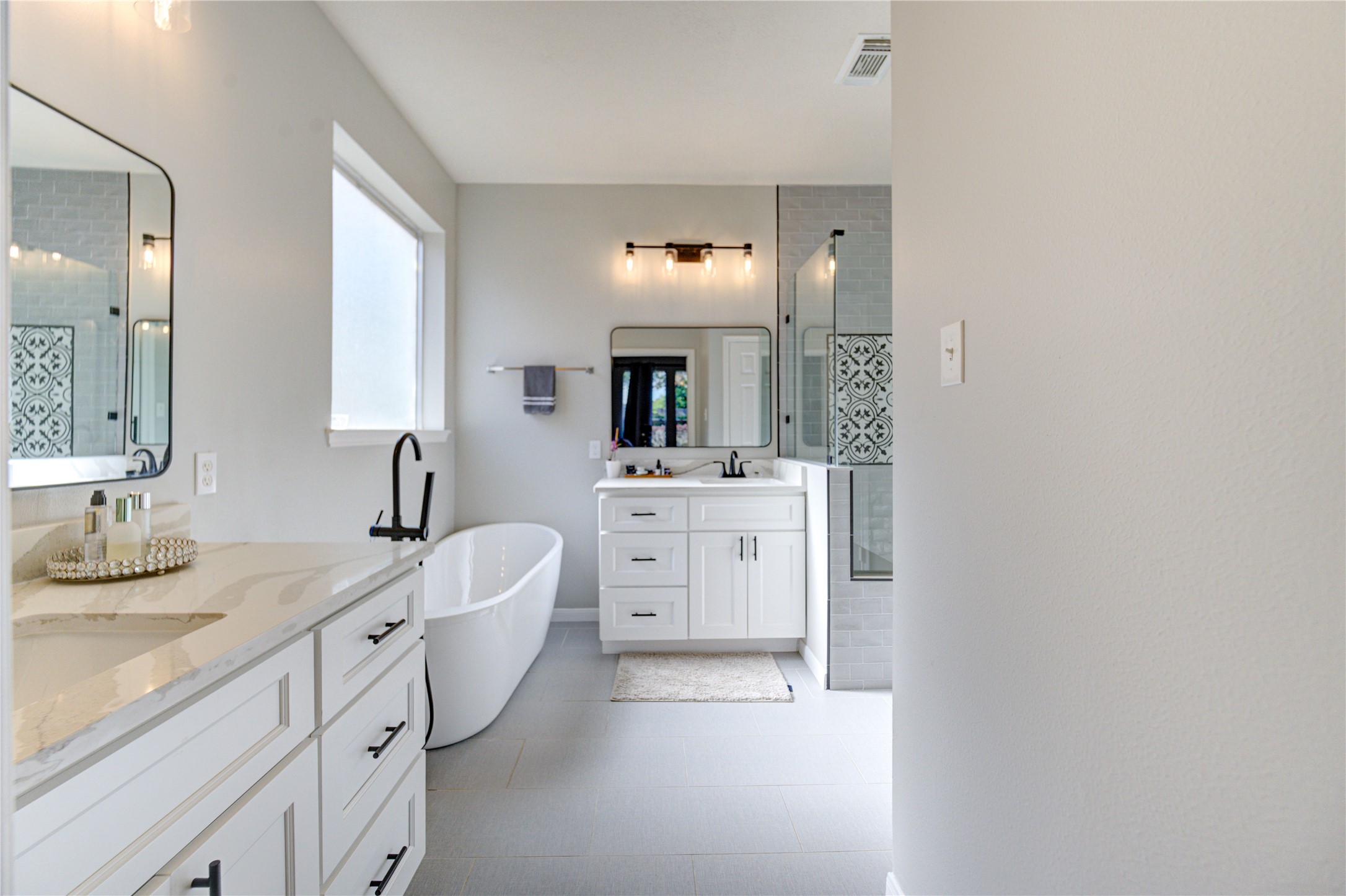 10906 Trail Ridge Drive Houston, TX 77064 - Photo 23 of 41 Elegant bath offering a stand-alone tub, separate shower, and two sinks.