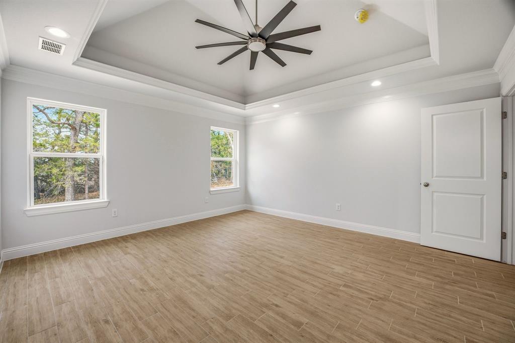 2017 Forest Bridge Azle, TX 76020 - Photo 16 of 30 Empty room featuring wood tiled floors, ceiling fan, recessed lighting, and crown molding