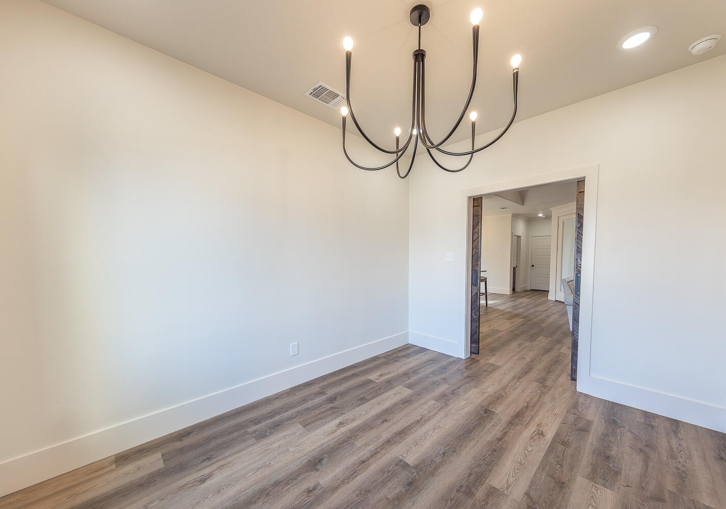 3605 143rd Street Lubbock, TX 79423 - Photo 13 of 34 a view of a room with wooden floor and white walls