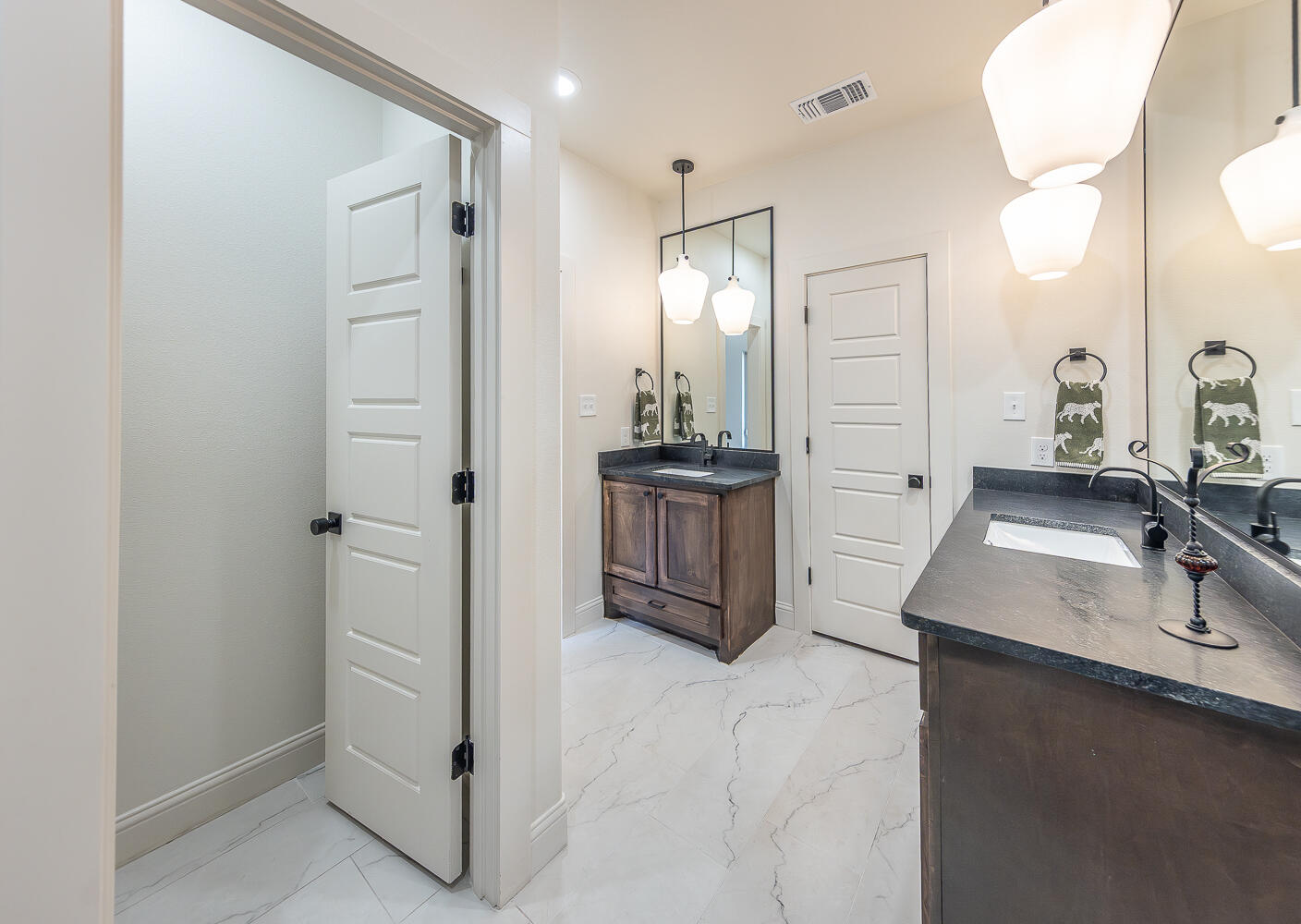 3605 143rd Street Lubbock, TX 79423 - Photo 18 of 34 a bathroom with a sink and a mirror