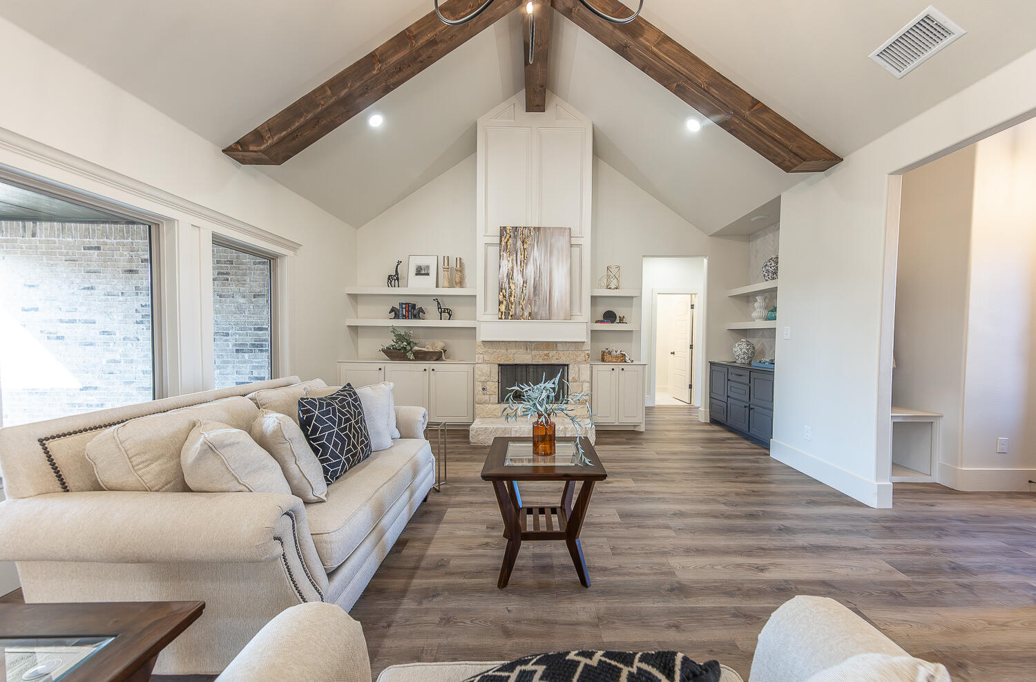 3605 143rd Street Lubbock, TX 79423 - Photo 2 of 34 a living room with furniture wooden floor and kitchen view