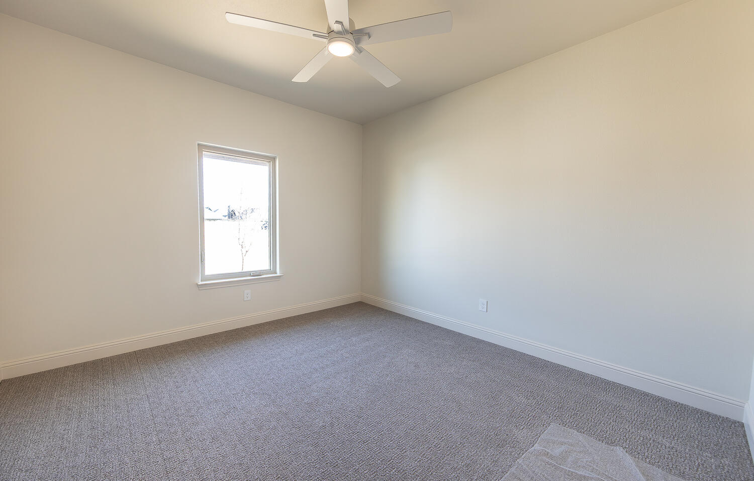 3605 143rd Street Lubbock, TX 79423 - Photo 25 of 34 an empty room with a window and a fan