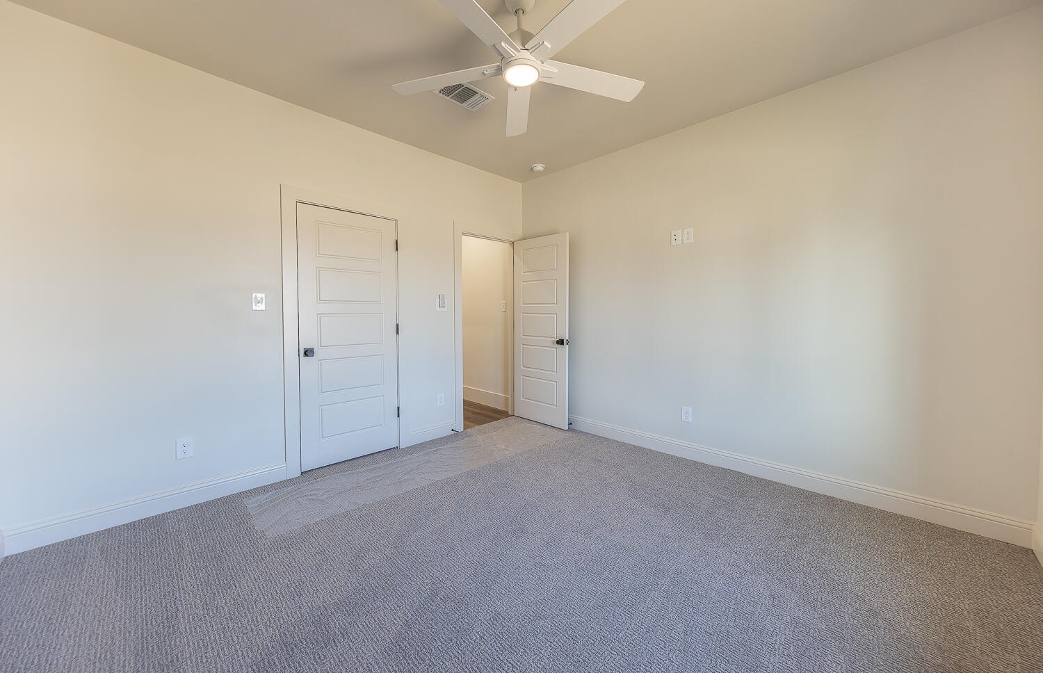 3605 143rd Street Lubbock, TX 79423 - Photo 26 of 34 an empty room with closet and a chandelier fan