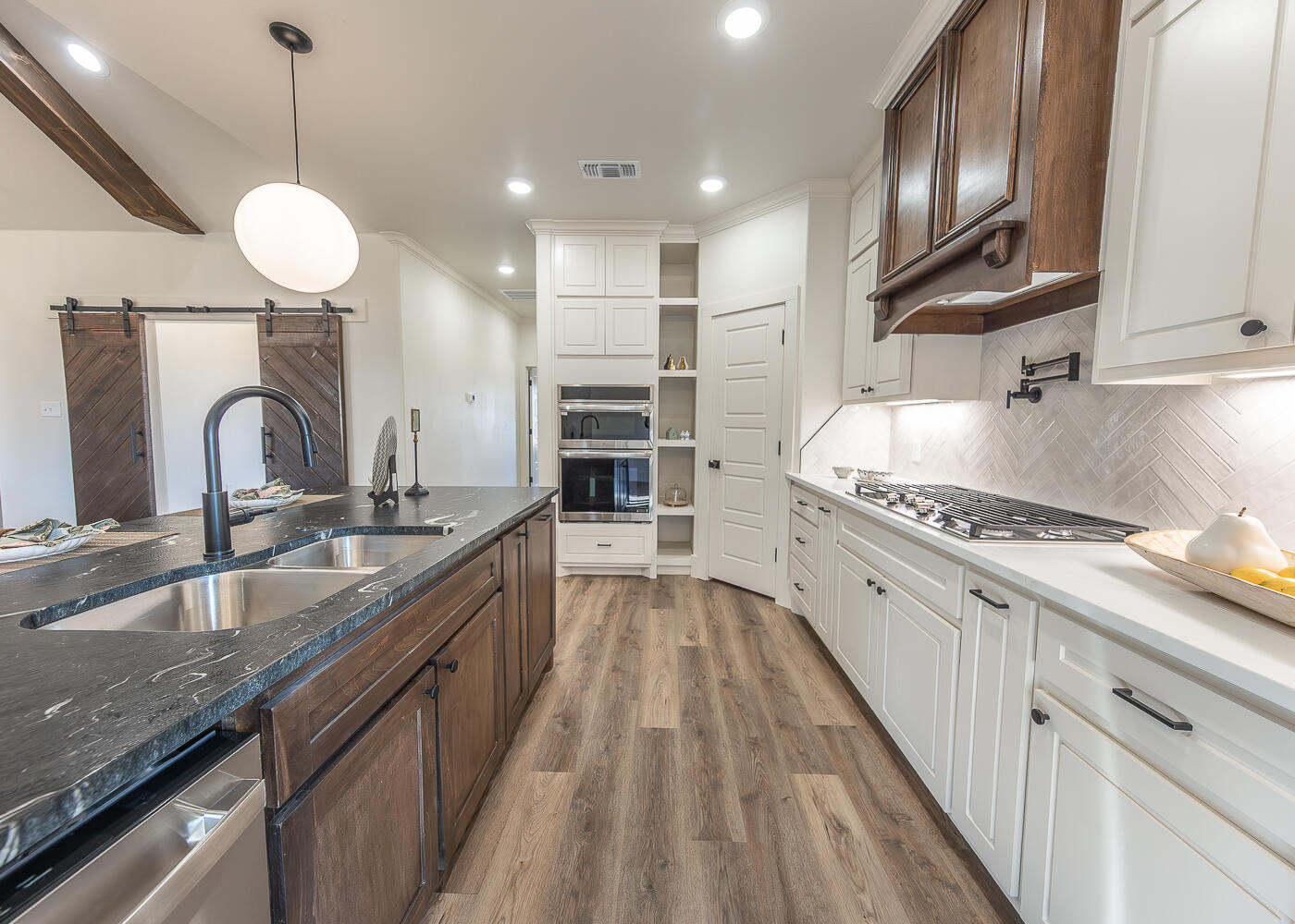 3605 143rd Street Lubbock, TX 79423 - Photo 3 of 34 a large kitchen with granite countertop a stove oven and a sink with granite countertops