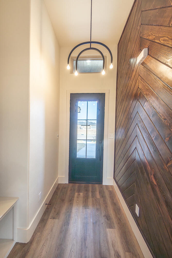 3605 143rd Street Lubbock, TX 79423 - Photo 5 of 34 a view of a room with wooden floor and white walls