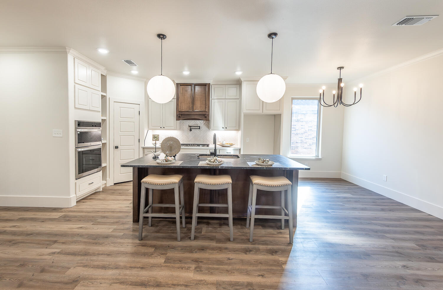 3605 143rd Street Lubbock, TX 79423 - Photo 8 of 34 a dining room with wooden floor a glass table and chairs