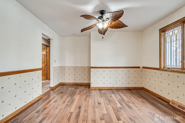 wooden floor in an empty room with a window