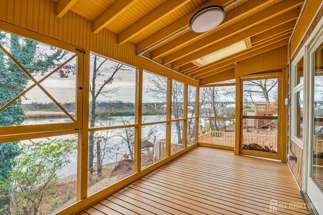 a view of a room with wooden floor and iron stairs