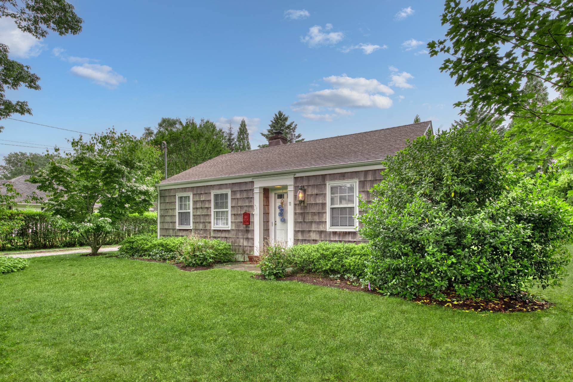 a view of a house with garden and yard