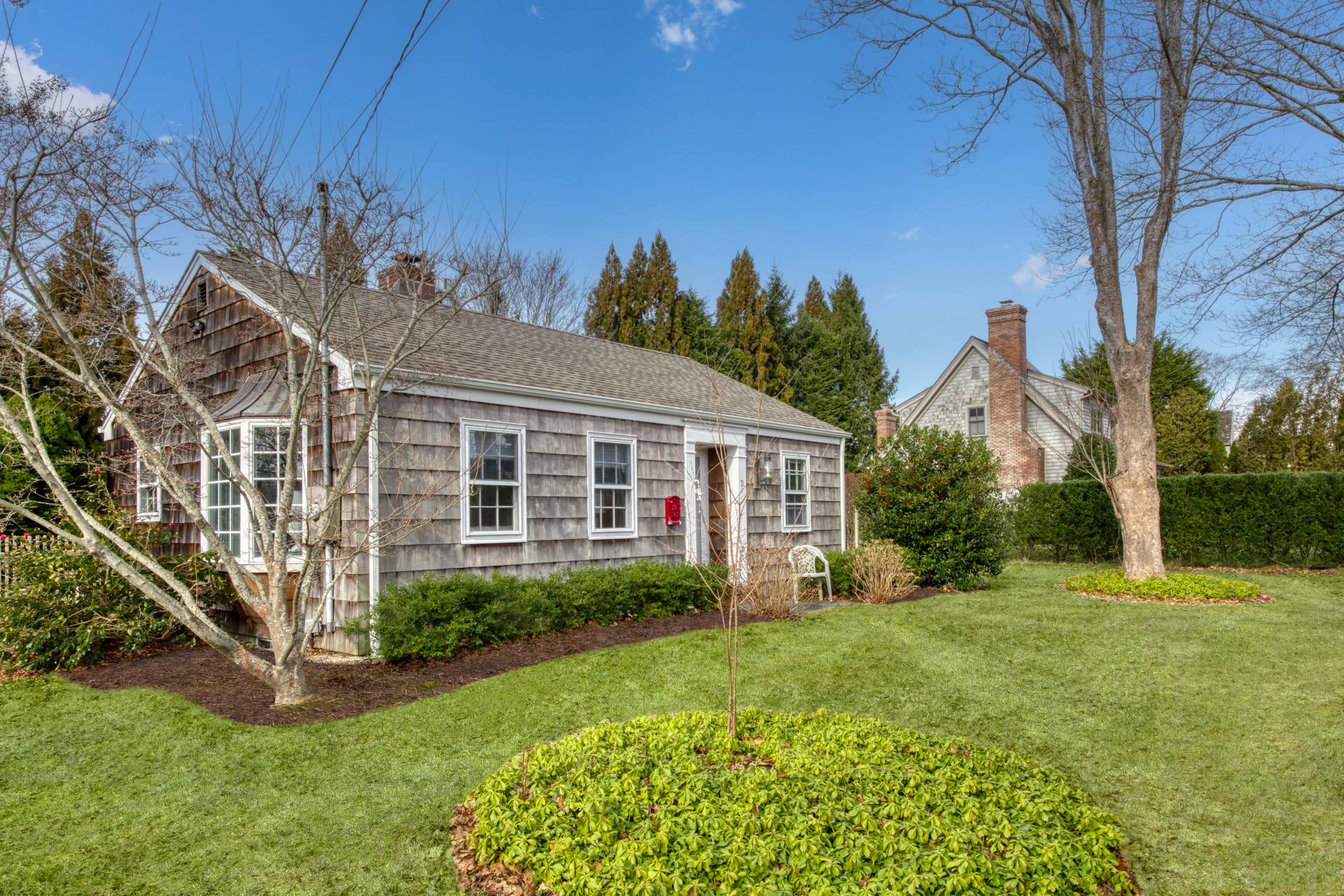 11 Maidstone Avenue East Hampton, NY 11937 - Photo 14 of 15 a view of a house next to a big yard and large trees