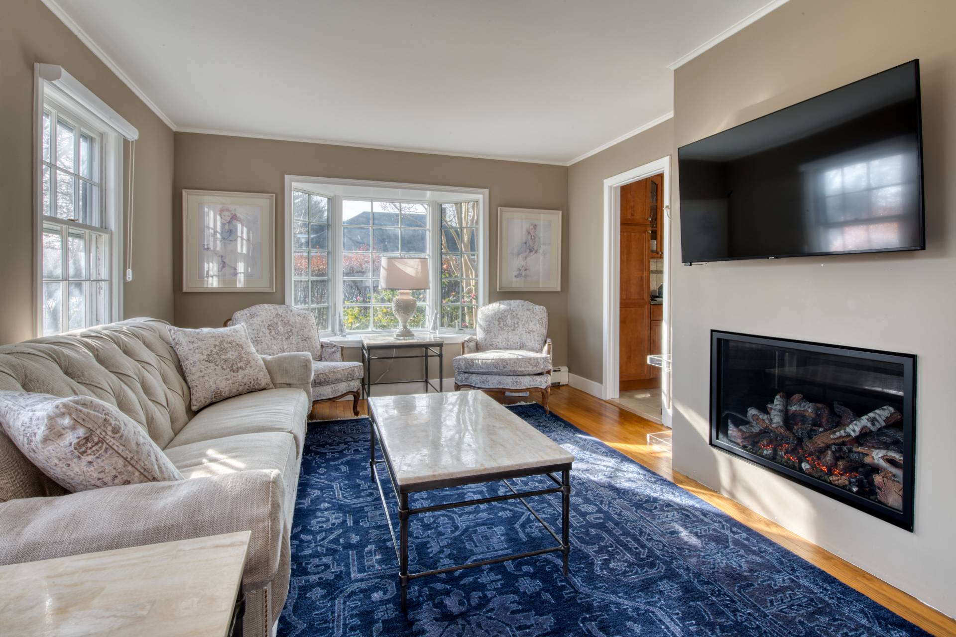 11 Maidstone Avenue East Hampton, NY 11937 - Photo 5 of 15 a living room with furniture a flat screen tv and a fireplace