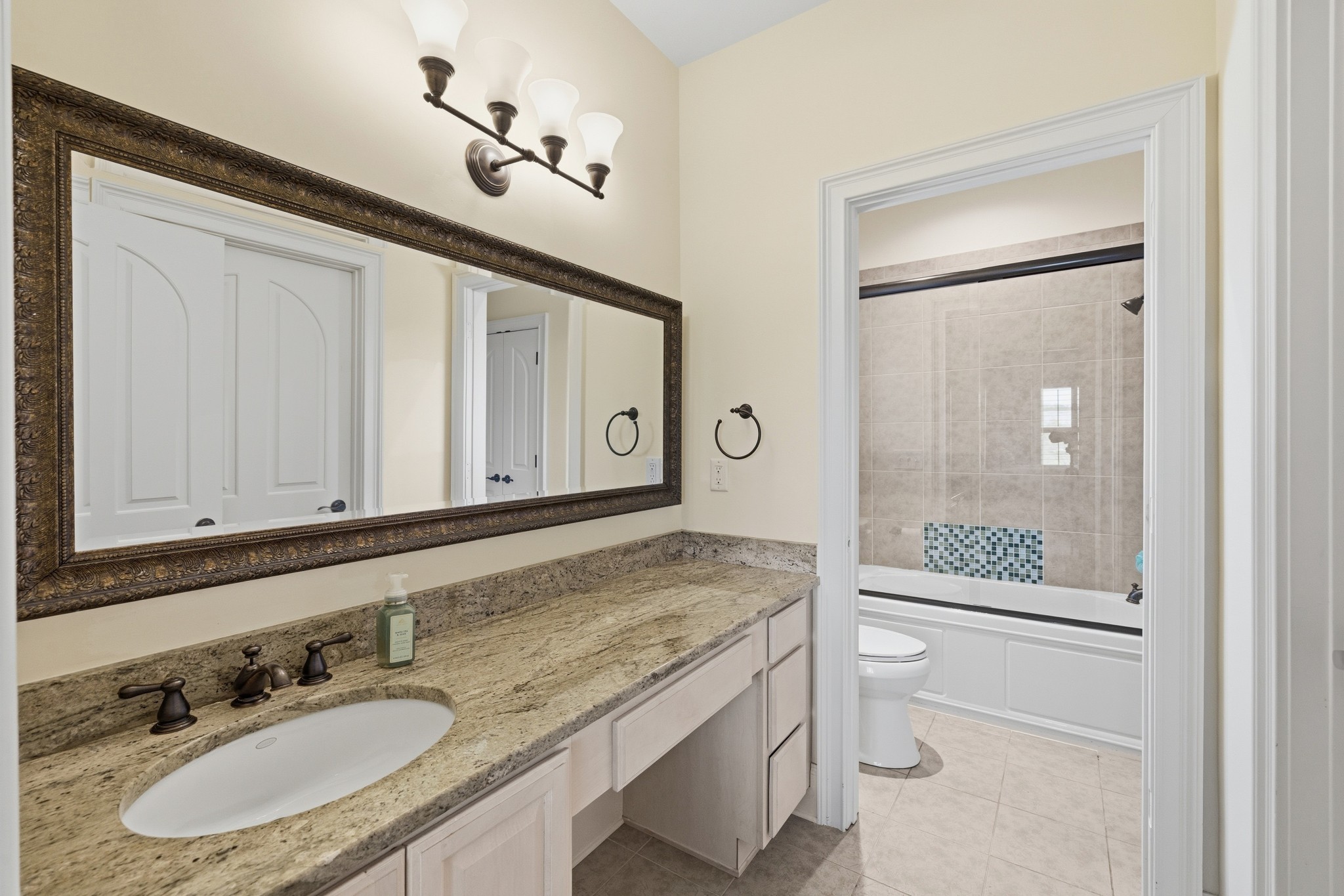 4606 Shores Road Murfreesboro, TN 37128 - Photo 40 of 74 a bathroom with a granite countertop sink a mirror and shower