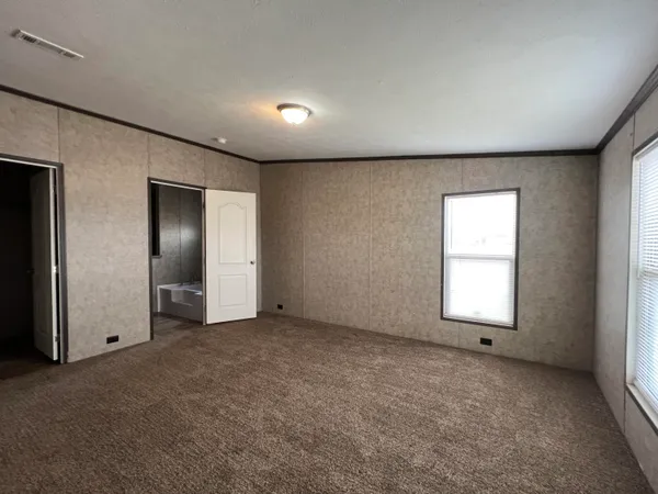 an empty room with windows and closet