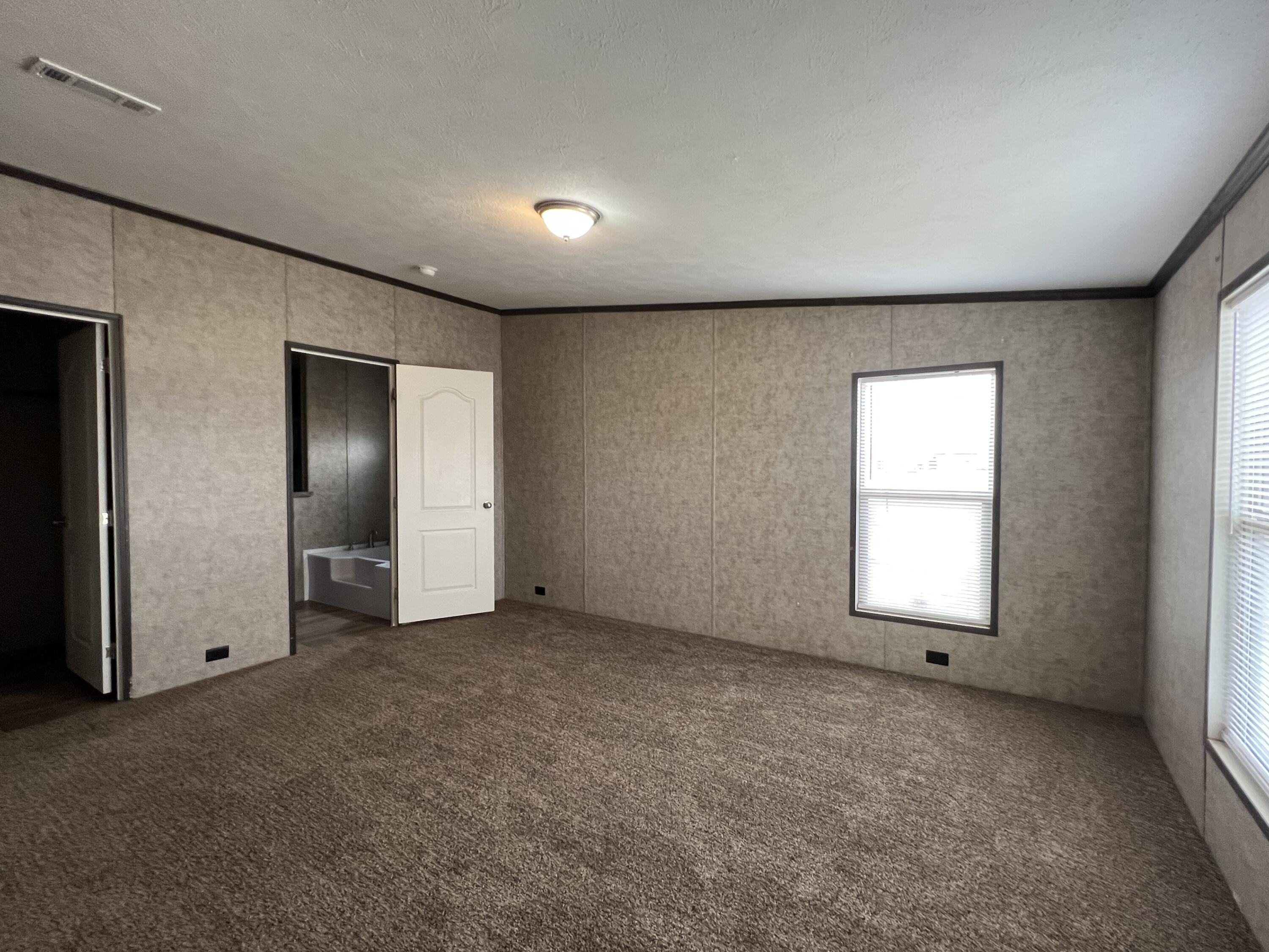 516 May Street Post, TX 79356 - Photo 15 of 31 an empty room with windows and closet