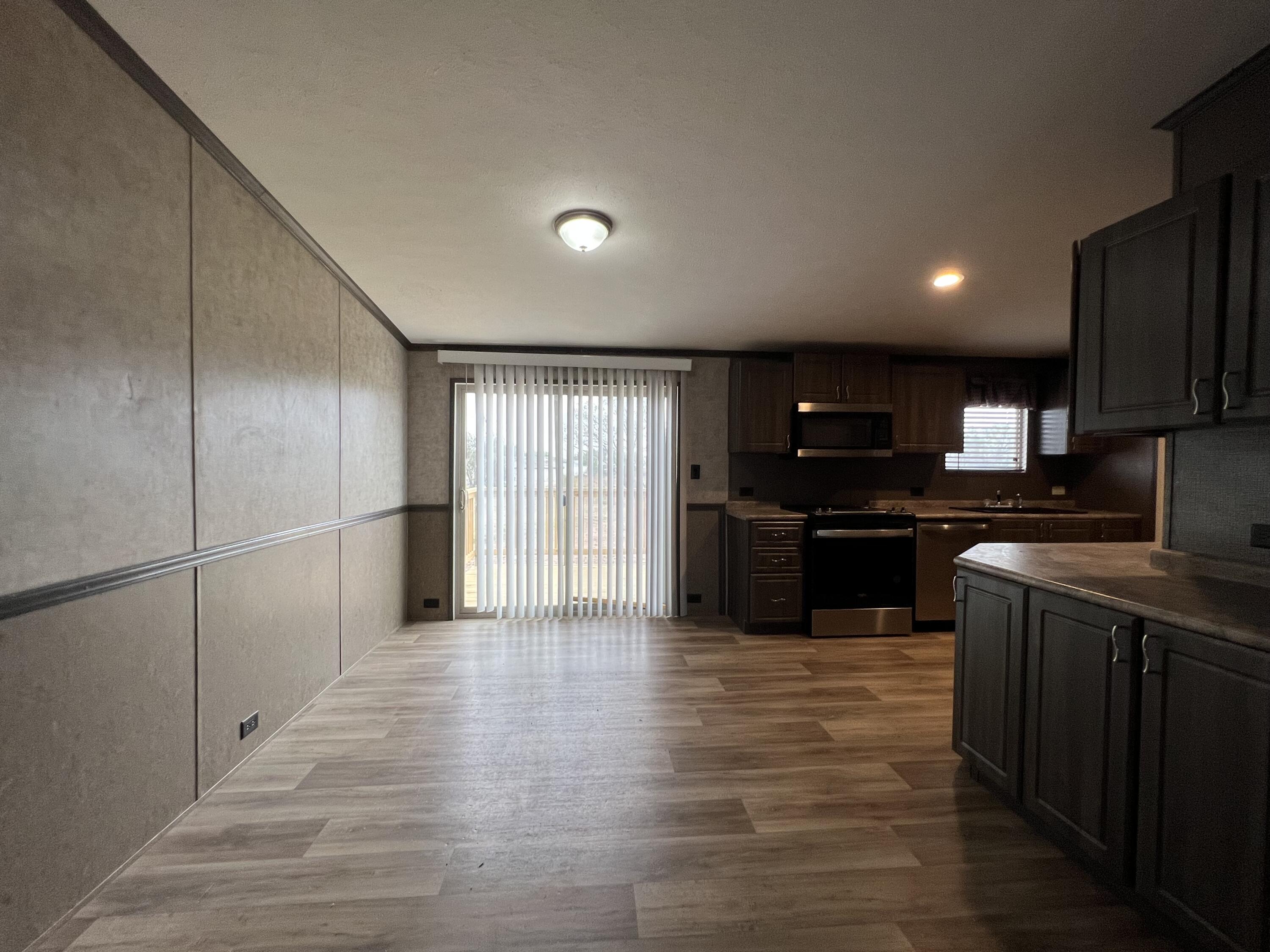 516 May Street Post, TX 79356 - Photo 9 of 31 a kitchen with stainless steel appliances granite countertop a refrigerator and a sink