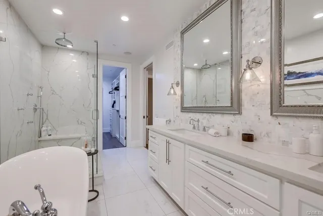 a bathroom with a double vanity sink mirror double and shower