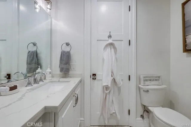 a bathroom with a double vanity sink toilet and shower