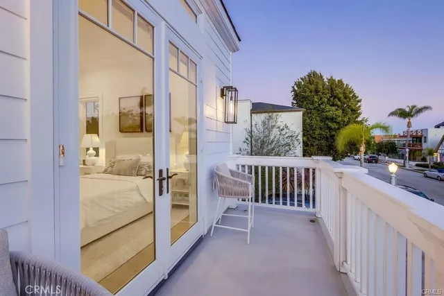 a view of hallway with bathroom and wooden floor