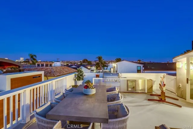 a view of a balcony with table and chairs