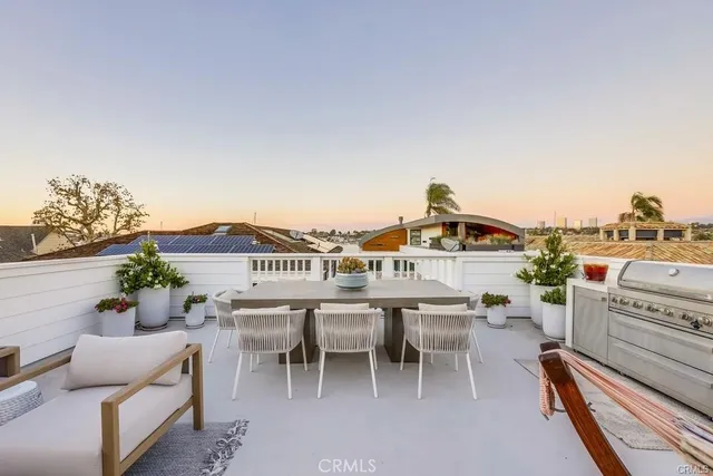a balcony with a table and chairs