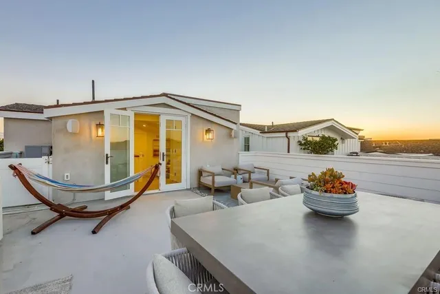 a view of a patio with table and chairs and potted plants