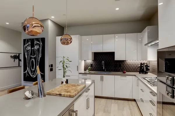 a kitchen with stainless steel appliances granite countertop a sink and a stove