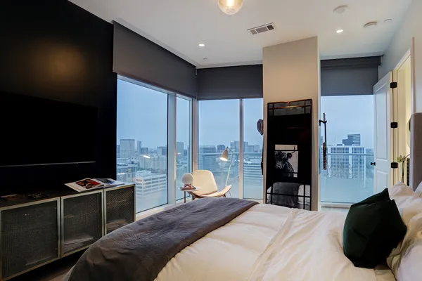 a kitchen with stainless steel appliances kitchen island granite countertop a dining table chairs refrigerator and sink