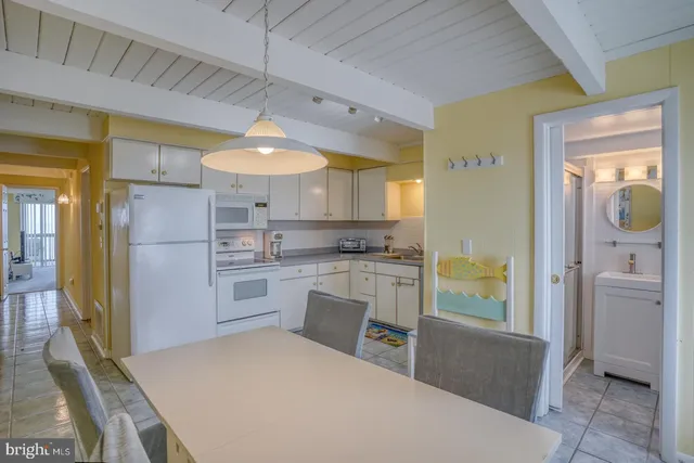 a kitchen with a refrigerator a sink and cabinets