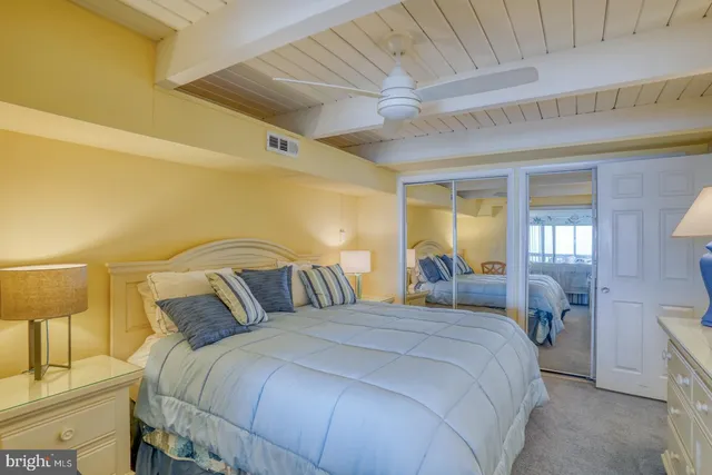 a bedroom with a bed and a lamp