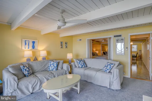 a living room with furniture and a glass door