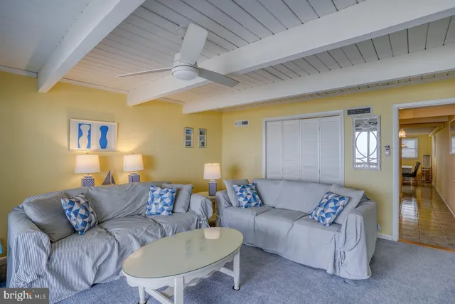 a bedroom with a bed and a lamp on the dresser