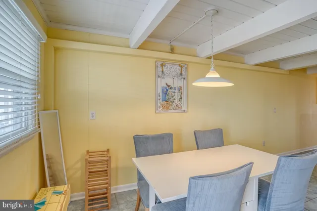 a view of a dining room with furniture and a chandelier