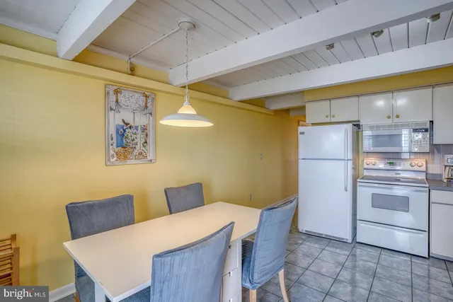 a kitchen with stainless steel appliances a refrigerator and a table