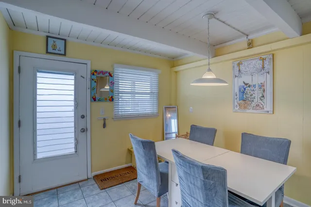 a view of a dining room with furniture and a window