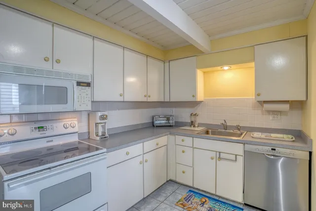a kitchen with a sink cabinets and window