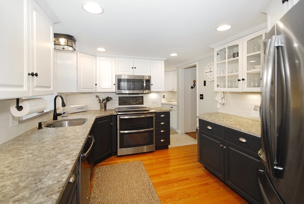 475 Lexington Road Concord, MA 01742 - Photo 16 of 42 a large kitchen with stainless steel appliances granite countertop a refrigerator a sink dishwasher and a stove