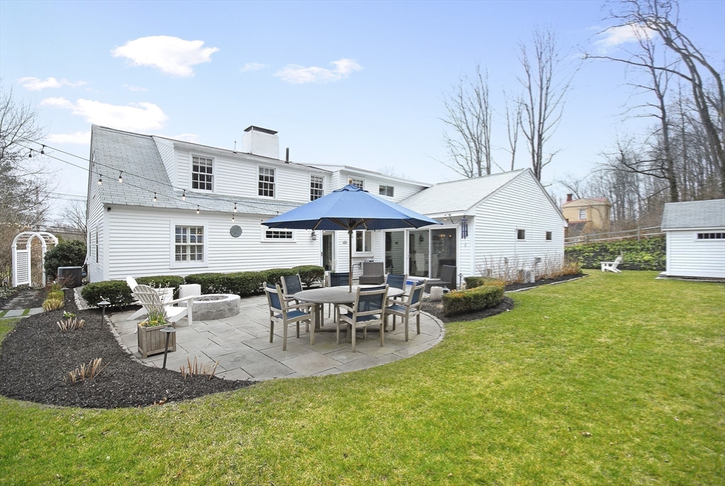 475 Lexington Road Concord, MA 01742 - Photo 38 of 42 a view of a house with backyard and sitting area