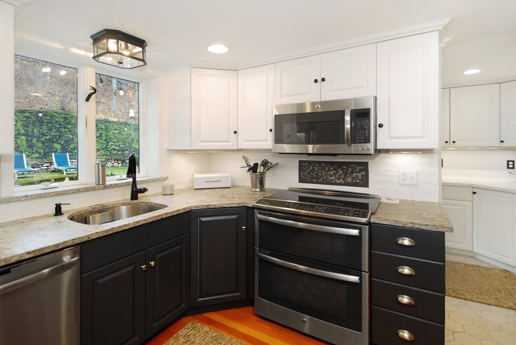 475 Lexington Road Concord, MA 01742 - Photo 5 of 42 a kitchen with a sink stove and microwave