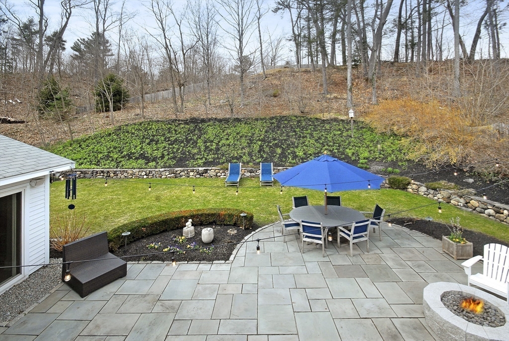 475 Lexington Road Concord, MA 01742 - Photo 10 of 42 a view of a swimming pool and lounge chairs in back yard of the house