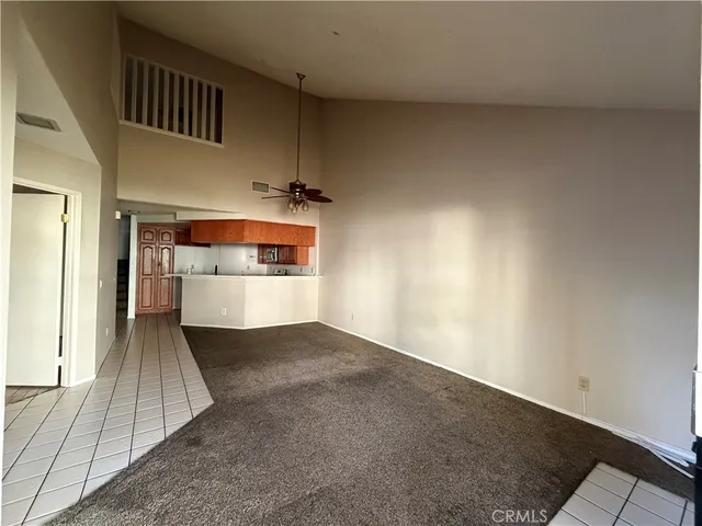 an empty room with a fireplace and cabinet