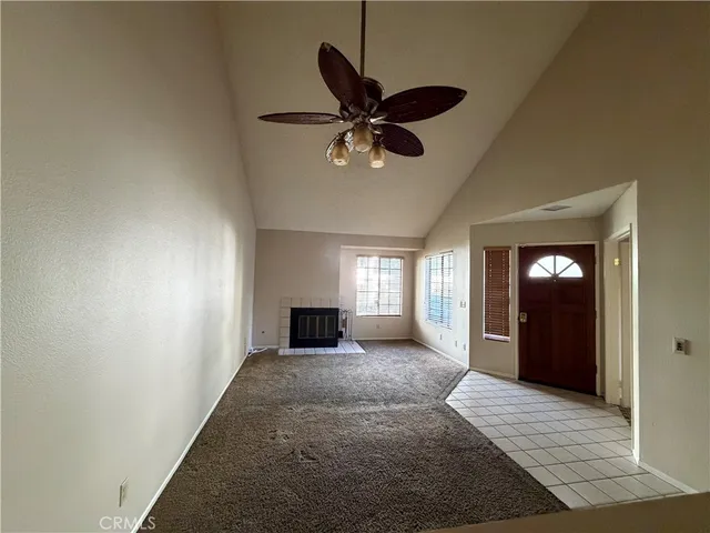 a view of a livingroom with a ceiling fan and window